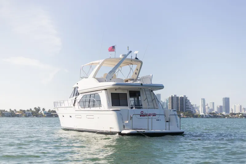 Salmonete Yacht Photos Pics 1999 Bayliner 5788 yacht cruising near city skyline on a sunny day.