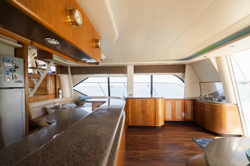 Salmonete Yacht Photos Pics Luxurious interior of 1999 Bayliner 5788 yacht with modern kitchen and panoramic windows.