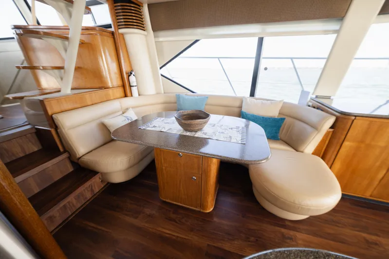 Salmonete Yacht Photos Pics Luxurious 1999 Bayliner 5788 yacht interior with elegant seating and wooden accents.