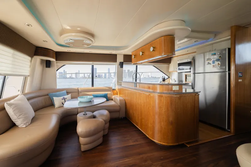 Salmonete Yacht Photos Pics Luxurious interior of a 1999 Bayliner 5788 yacht with modern kitchen and seating area.