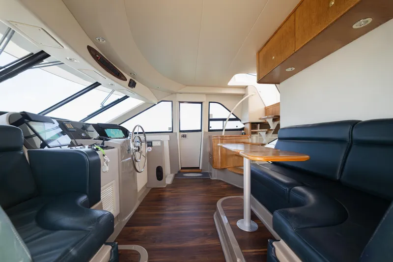 Salmonete Yacht Photos Pics Interior of a 1999 Bayliner 5788 yacht with leather seating and wooden accents.