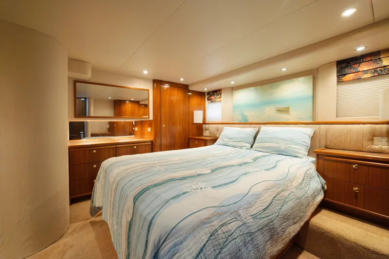 Salmonete Yacht Photos Pics Luxurious bedroom interior of 1999 Bayliner 5788 yacht with elegant wood furnishings.