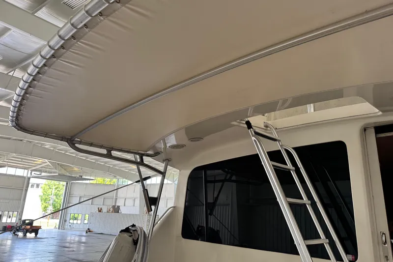 City Island Yacht Photos Pics 2005 Fifth Ocean Yachts 46 SS with ladder and canopy in a spacious indoor setting.