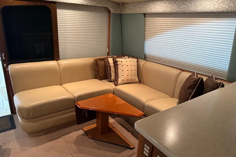 City Island Yacht Photos Pics Luxurious interior of 2005 Fifth Ocean Yachts 46 SS with beige leather seating and decorative pillows.