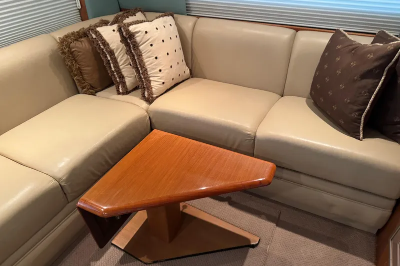 City Island Yacht Photos Pics Luxurious interior of 2005 Fifth Ocean Yachts 46 SS with beige sofa and decorative pillows.