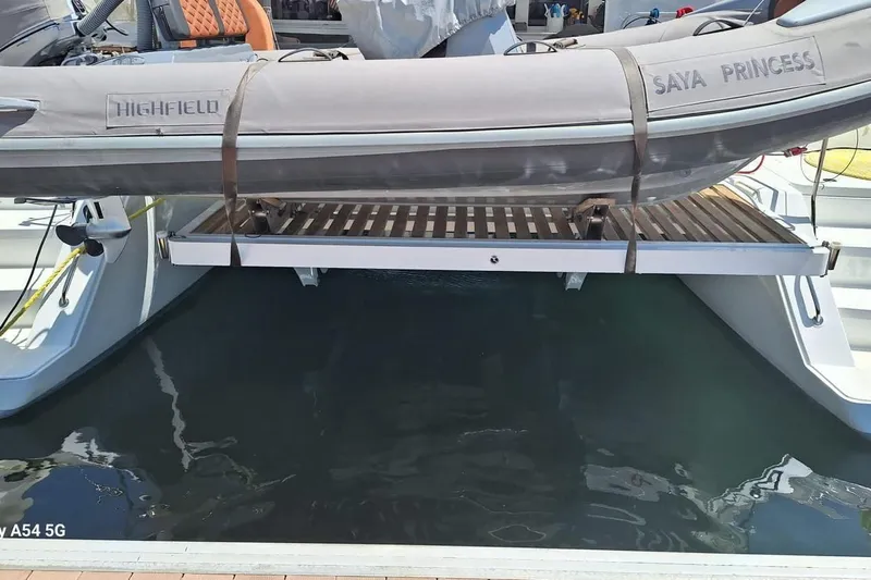  Yacht Photos Pics Lagoon 450 F 2018 catamaran with Highfield tender, docked at marina.
