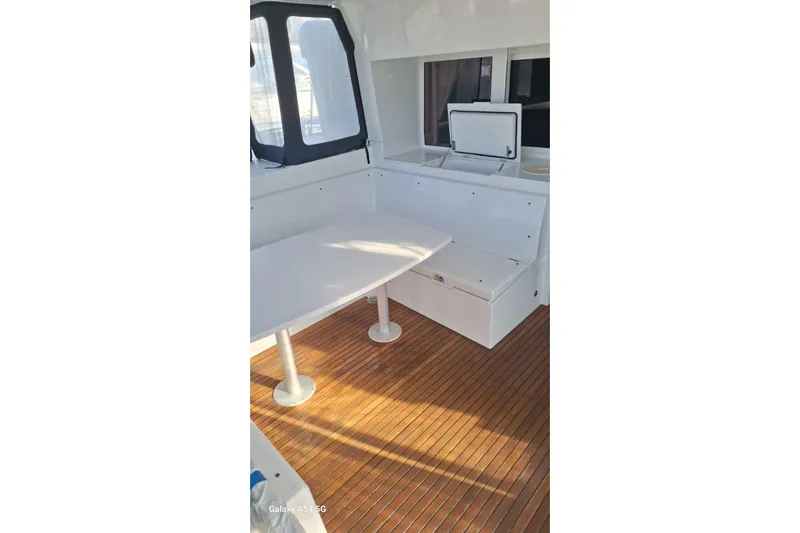  Yacht Photos Pics Interior of 2018 Lagoon 450 F yacht with wooden flooring and white seating area.