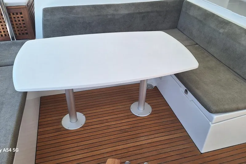  Yacht Photos Pics Interior seating area of a 2018 Lagoon 450 F catamaran with a white table.