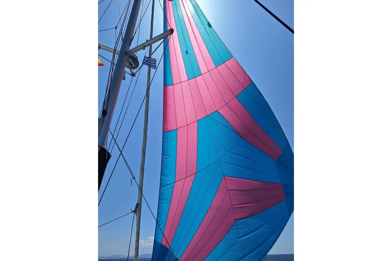  Yacht Photos Pics Colorful sail on a 2018 Lagoon 450 F catamaran against a clear blue sky.
