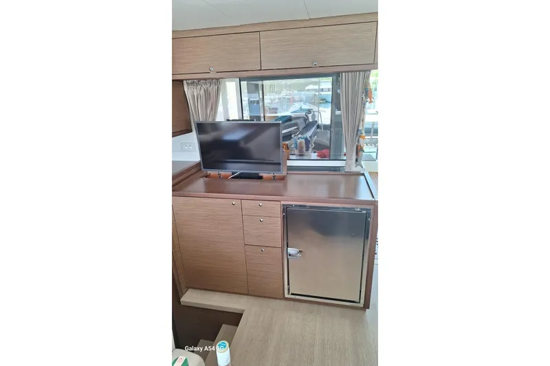  Yacht Photos Pics Interior of 2018 Lagoon 450 F yacht with TV and mini fridge.