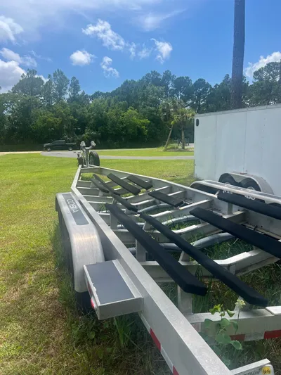 No Name Yacht Photos Pics Boat trailer for 2015 Cobia 344 Center Console on grassy area, sunny day.
