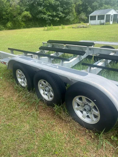 No Name Yacht Photos Pics Triple-axle boat trailer on grass, suitable for 2015 Cobia 344 Center Console.