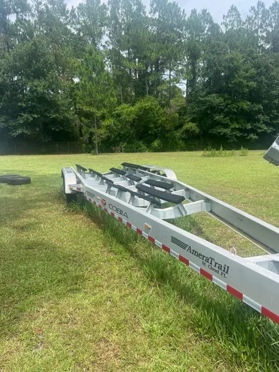 No Name Yacht Photos Pics Boat trailer for 2015 Cobia 344 Center Console on grassy field.