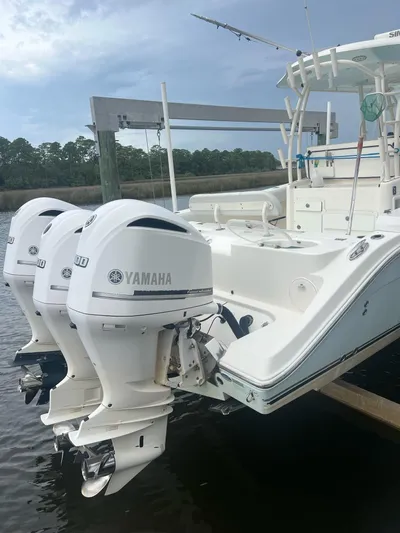 No Name Yacht Photos Pics 2015 Cobia 344 Center Console boat with Yamaha outboard engines docked by the water.