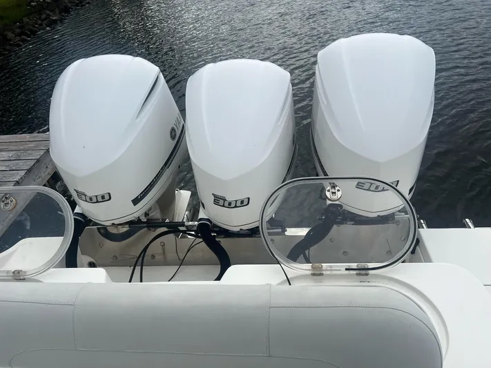 No Name Yacht Photos Pics 2015 Cobia 344 Center Console with triple outboard engines on water.