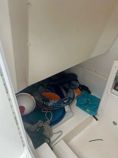 No Name Yacht Photos Pics Storage compartment of 2015 Cobia 344 Center Console with ropes and life jackets.