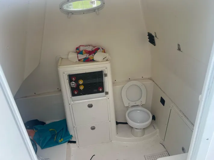 No Name Yacht Photos Pics Interior of 2015 Cobia 344 Center Console boat with toilet and storage cabinet.