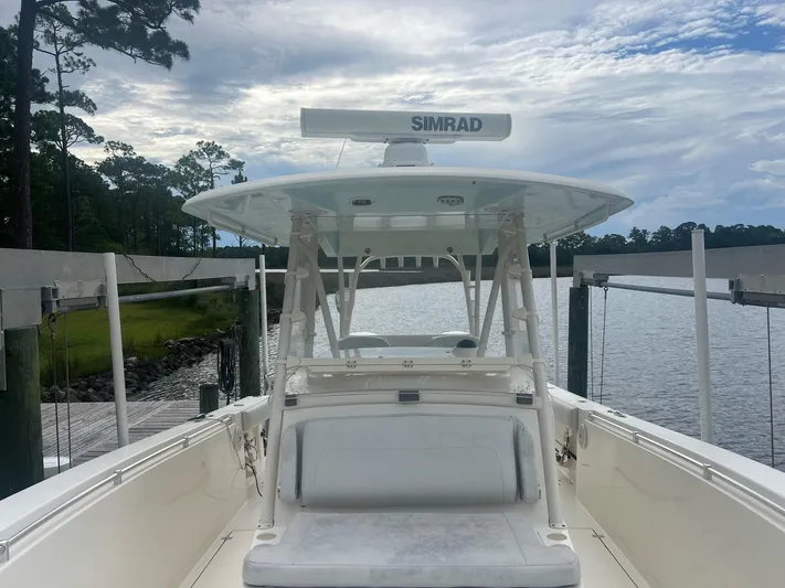 No Name Yacht Photos Pics 2015 Cobia 344 Center Console boat docked by a serene lake under a cloudy sky.