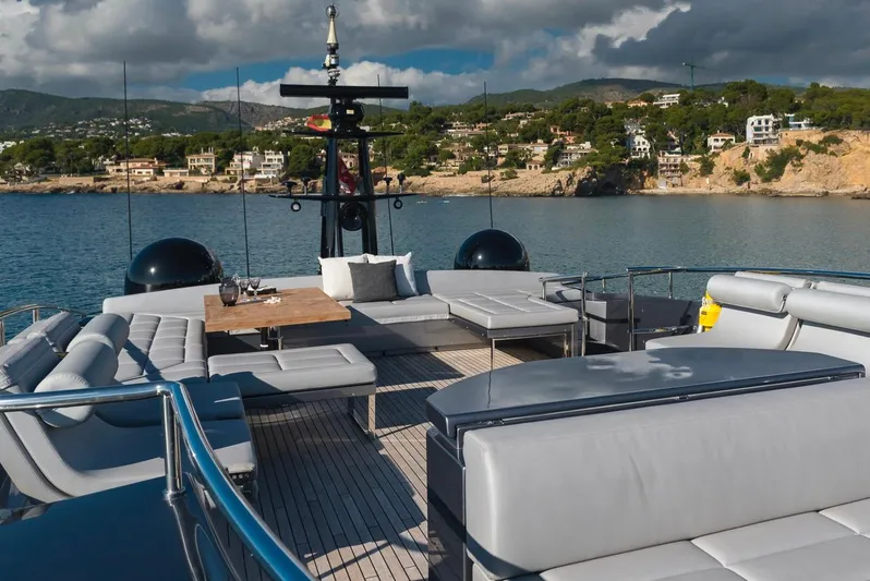 Aldebaran III Yacht Photos Pics Luxurious 2018 Pershing 108 yacht deck with modern seating, overlooking scenic coastal view.
