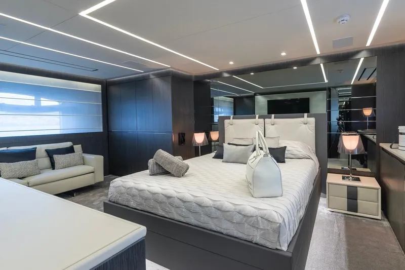 Aldebaran III Yacht Photos Pics Luxurious bedroom interior on a 2018 Pershing 108 yacht, featuring modern design and elegant furnishings.