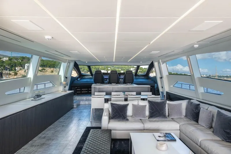 Aldebaran III Yacht Photos Pics Luxurious interior of 2018 Pershing 108 yacht with modern seating and panoramic windows.