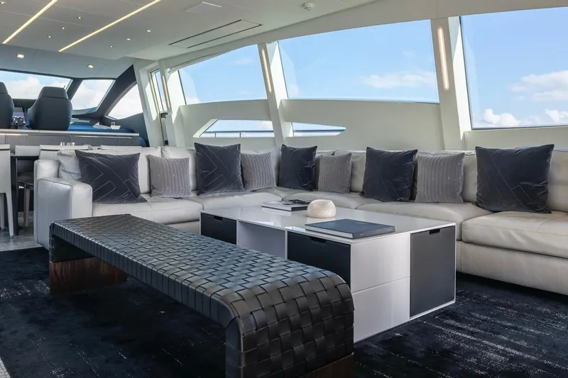 Aldebaran III Yacht Photos Pics Luxurious interior of a 2018 Pershing 108 yacht with modern seating and panoramic windows.