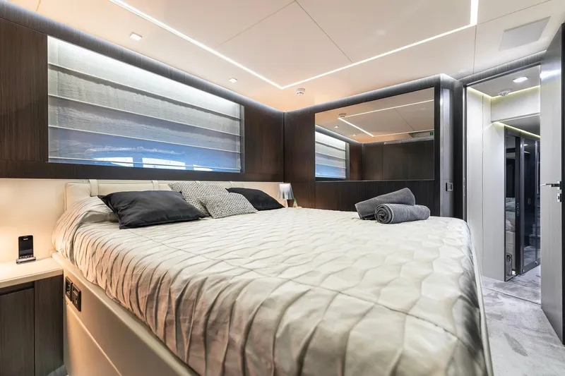 Aldebaran III Yacht Photos Pics Luxurious bedroom interior of 2018 Pershing 108 yacht with modern design and elegant bedding.