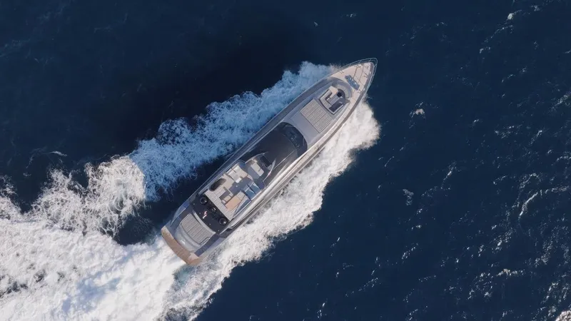 Aldebaran III Yacht Photos Pics Aerial view of 2018 Pershing 108 yacht cruising through deep blue ocean waters.
