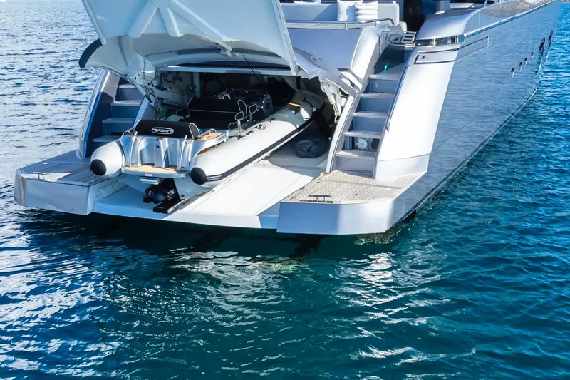 Aldebaran III Yacht Photos Pics Luxury Pershing 108 yacht with tender garage open, showcasing sleek design on the water.