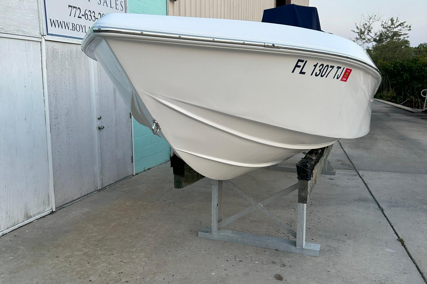 2022 Paramount 21 boat on stand, white hull, registration FL 1307 TJ.