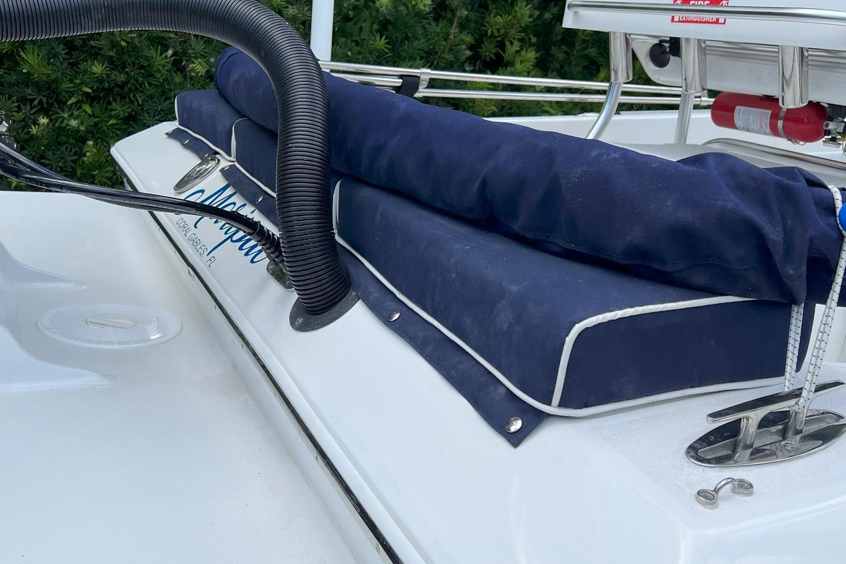 2022 Paramount 21 boat with blue cushions and safety equipment on deck.