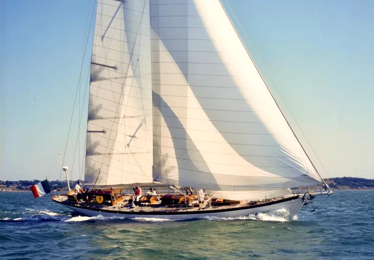 Juliette Yacht Photos Pics Vintage 1929 Custom Cutter Marconi sailboat gliding on open water under clear skies.