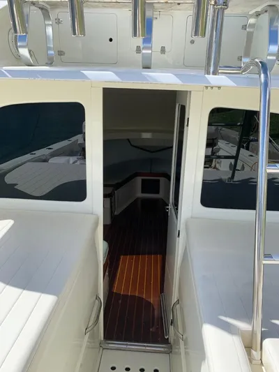 Legacy Yacht Photos Pics 1973 Bertram 31 Flybridge Cruiser interior with wooden flooring and seating.