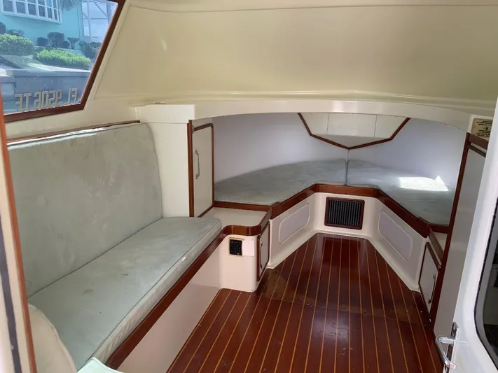 Legacy Yacht Photos Pics 1973 Bertram 31 Flybridge Cruiser interior with wood flooring and cushioned seating.