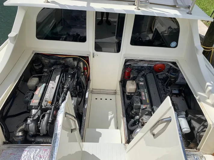 Legacy Yacht Photos Pics 1973 Bertram 31 Flybridge Cruiser engine compartment with dual engines visible.