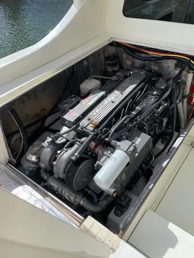 Legacy Yacht Photos Pics Engine compartment of a 1973 Bertram 31 Flybridge Cruiser, showcasing detailed mechanical components.