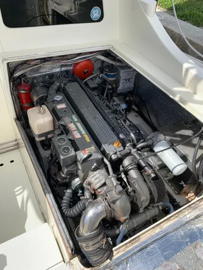 Legacy Yacht Photos Pics Engine compartment of a 1973 Bertram 31 Flybridge Cruiser, showcasing detailed mechanical components.