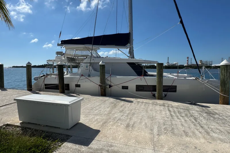 Ce Ya Yacht Photos Pics 2021 Leopard 45 catamaran docked by the waterfront under a clear blue sky.