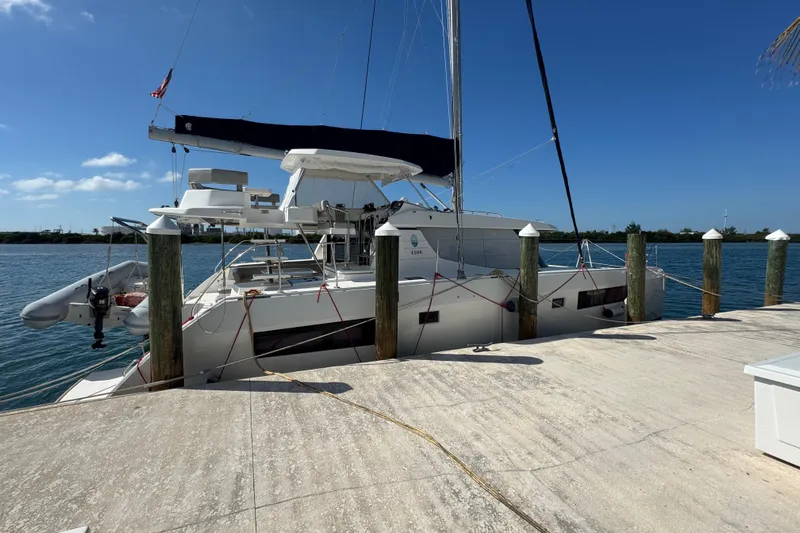 Ce Ya Yacht Photos Pics 2021 Leopard 45 catamaran docked at a marina under clear blue skies.