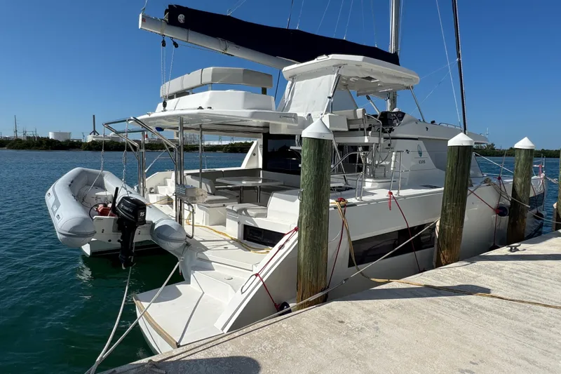 Ce Ya Yacht Photos Pics 2021 Leopard 45 catamaran docked, featuring spacious deck and attached dinghy.