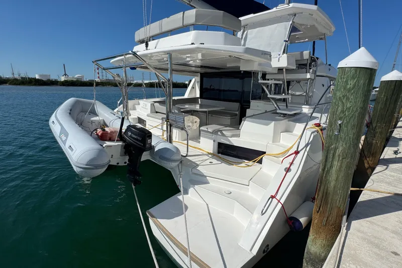 Ce Ya Yacht Photos Pics 2021 Leopard 45 catamaran docked with inflatable dinghy and outboard motor.