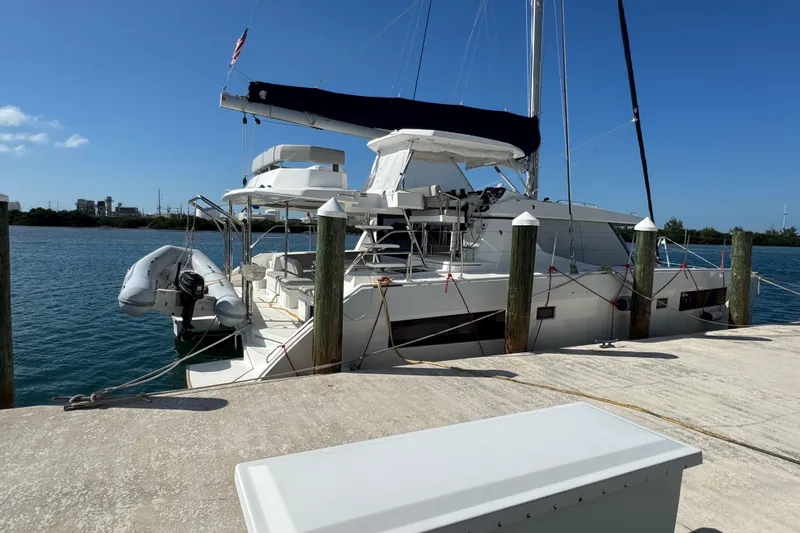 Ce Ya Yacht Photos Pics 2021 Leopard 45 catamaran docked at a marina under clear blue skies.