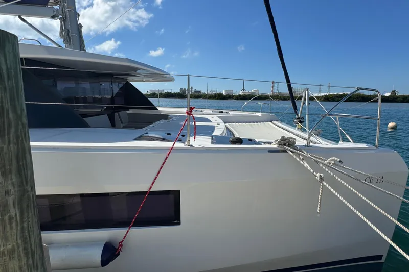 Ce Ya Yacht Photos Pics 2021 Leopard 45 catamaran docked on a sunny day with clear blue skies.