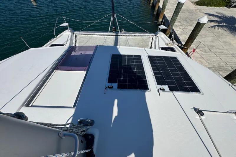 Ce Ya Yacht Photos Pics 2021 Leopard 45 catamaran with solar panels on deck, docked at marina.