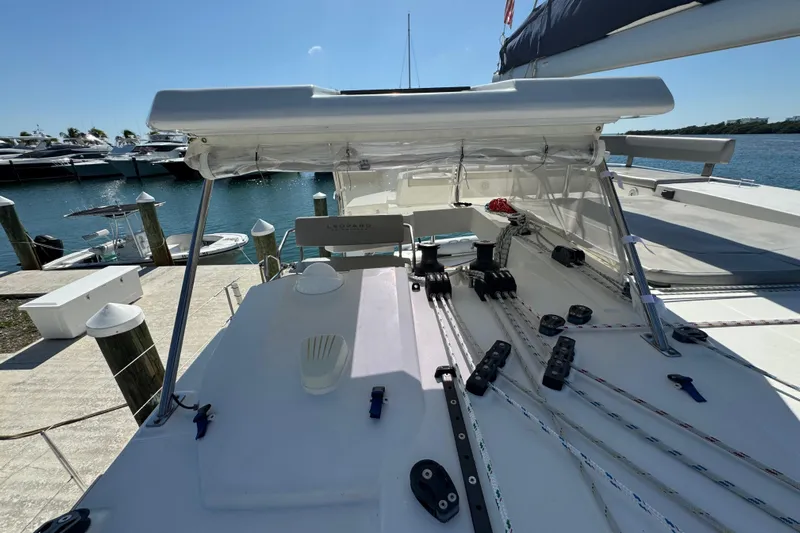 Ce Ya Yacht Photos Pics 2021 Leopard 45 catamaran deck with rigging, docked at marina.