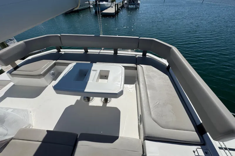 Ce Ya Yacht Photos Pics Leopard 45 catamaran 2021 model, featuring spacious outdoor seating and table, docked by the water.