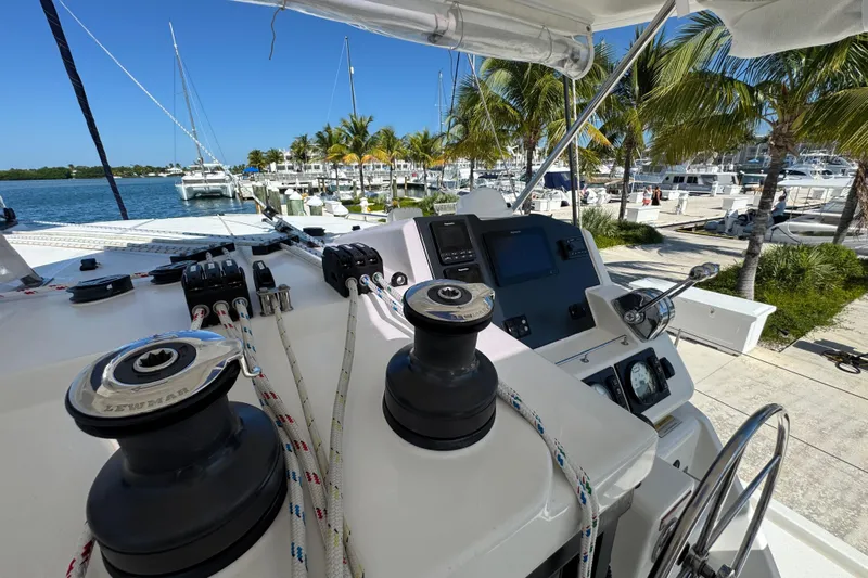 Ce Ya Yacht Photos Pics Helm of 2021 Leopard 45 catamaran docked at marina with palm trees.