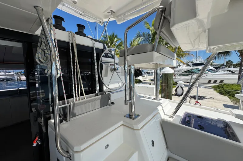 Ce Ya Yacht Photos Pics Leopard 45 yacht helm station with ropes and steering wheel, docked at marina.