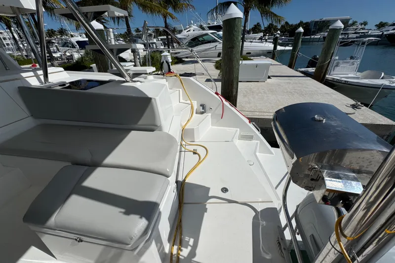 Ce Ya Yacht Photos Pics Leopard 45 catamaran deck with seating and grill, docked at marina, 2021 model.