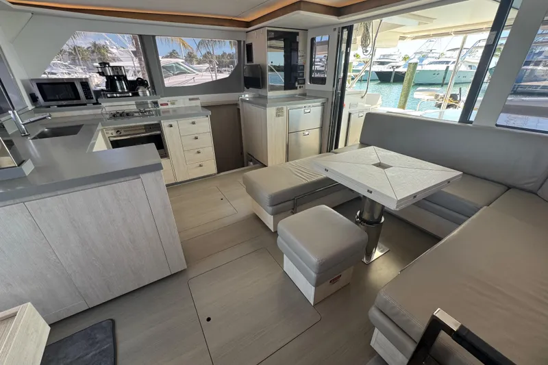 Ce Ya Yacht Photos Pics Modern interior of 2021 Leopard 45 catamaran with kitchen and seating area.